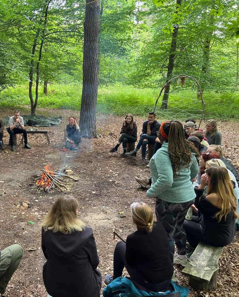 team meeting around the campfire